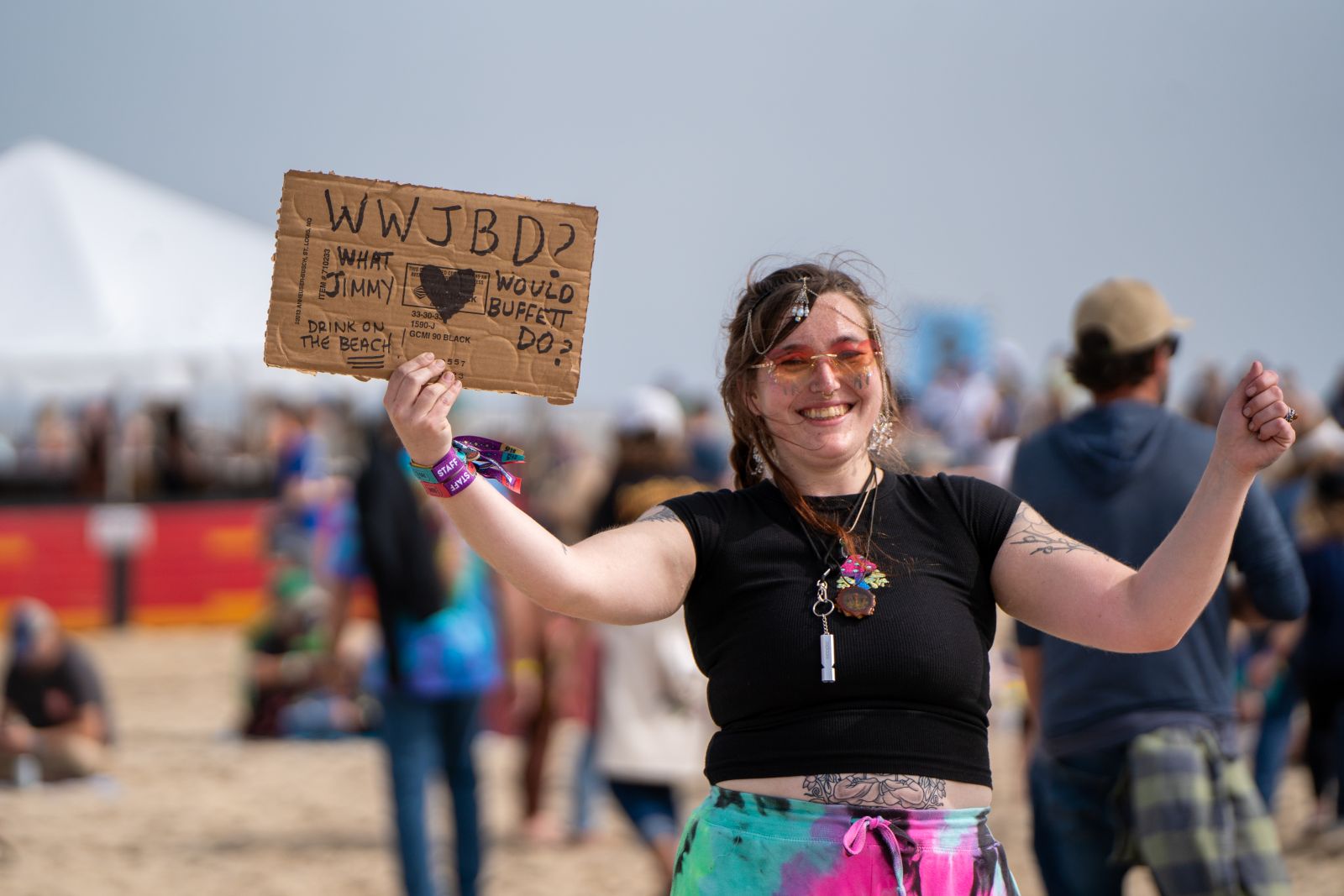 Girl holding a cardboard sign on the beach